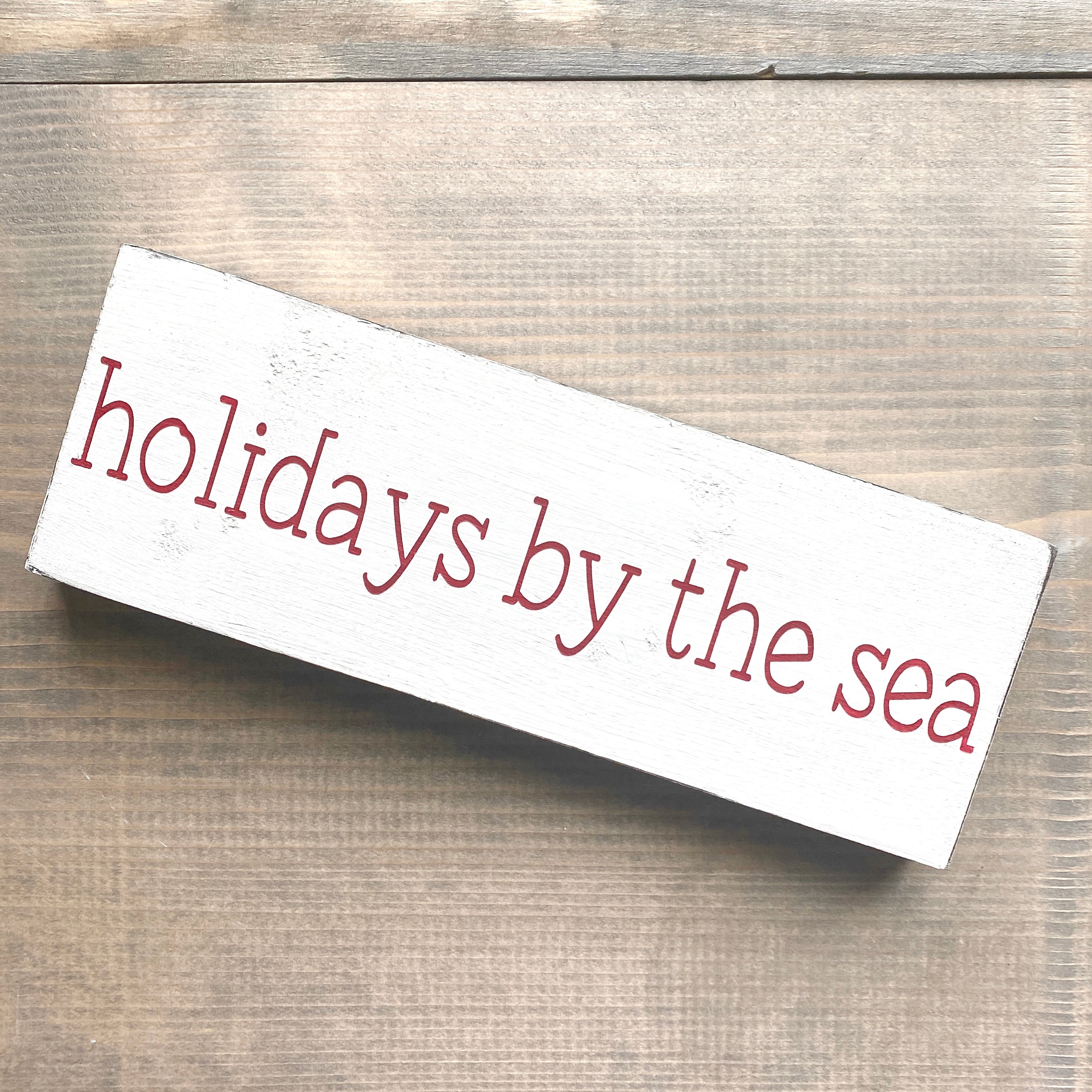 Holidays by the sea sign